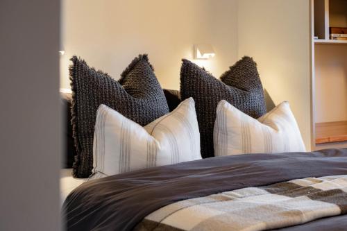 a bedroom with a bed with black and white pillows at 25 Walkers Lane in Bright