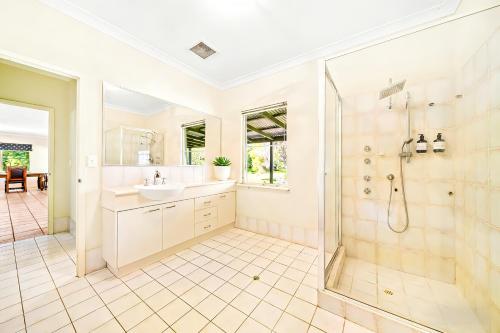 a bathroom with a shower and a sink at Cockburn Airoprt 6BR Farmstay nr Fremantle&Beach in Perth