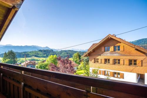 a view from the balcony of a wooden house at Bergzitt in Ofterschwang
