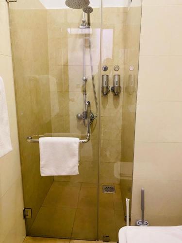 a shower in a bathroom with a glass door at Coastal Cocoon Studio - Negombo in Negombo