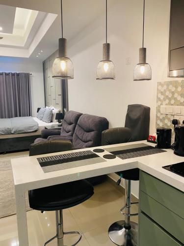 a kitchen and living room with a desk with a keyboard at Coastal Cocoon Studio - Negombo in Negombo