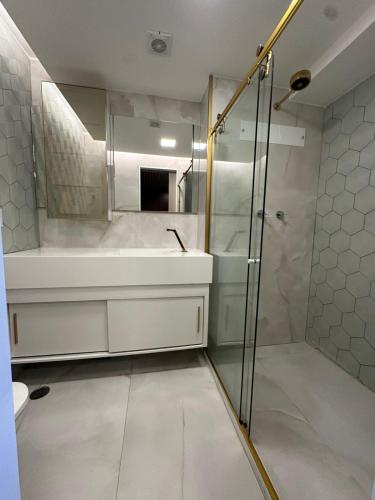 a bathroom with a shower and a tub and a sink at Refuge Beira Mar - Boa Viagem in Recife