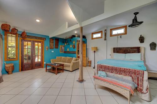a bedroom with a bed and a living room at Sweet Spot Stay - Tropical TreeTops Home in Pahoa