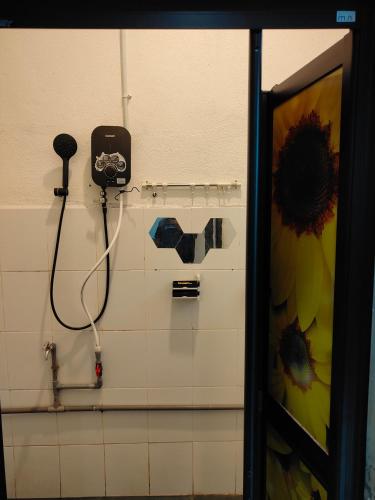 a bathroom with a shower with a phone on the wall at Penarik baru homestay in Kampung Penarik
