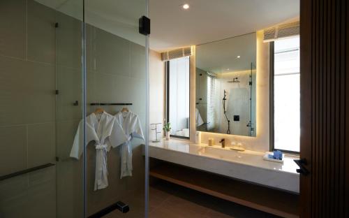 a bathroom with a sink and a large mirror at Top sea villa in Ban Bo Yai