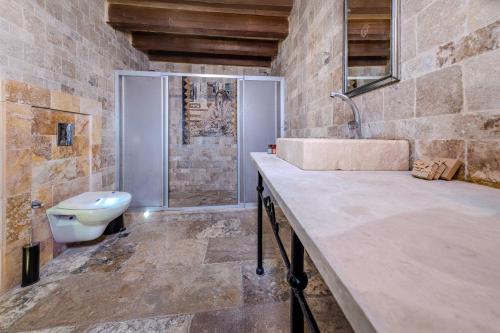 a bathroom with a sink and a toilet at Panoramic Cave Hotel in Goreme