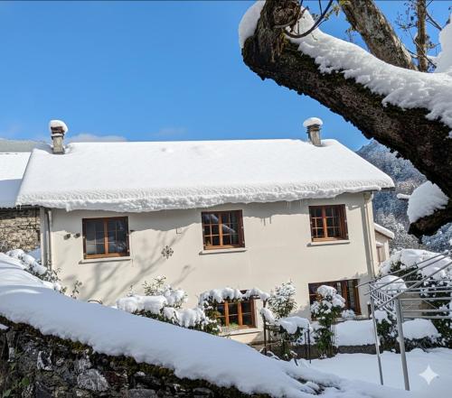a house covered in snow at Le Gite 5 mn de Luchon - Jardin garage et parking in Benque-Dessous-et-Dessus