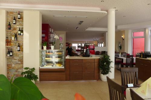 a man standing at a counter in a restaurant at Hotel & Ristorante Passarelli in Warthausen