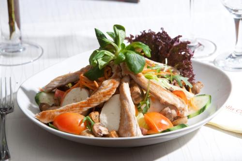 a white plate of food on a table at Hotel & Ristorante Passarelli in Warthausen