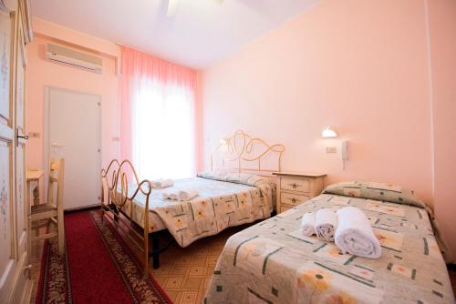 Postel nebo postele na pokoji v ubytování Hotel Settebello B&B