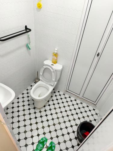 a small bathroom with a toilet and a sink at Serai Homestay in Dungun