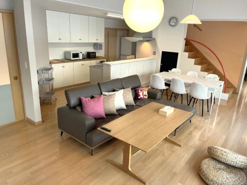 a living room with a couch and a table at Villa和心 in Asahikawa