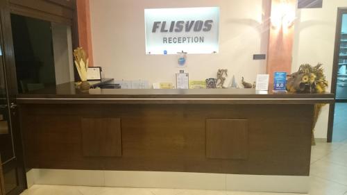 a lobby with a reception desk in a building at Flisvos Rooms in Livanátai