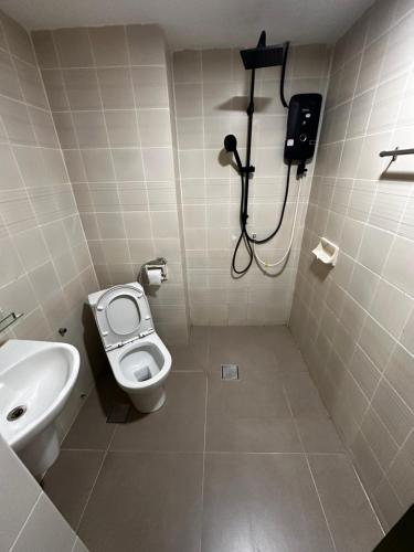 a bathroom with a toilet and a sink and a shower at The Regency PortDickson A1-7 in Port Dickson