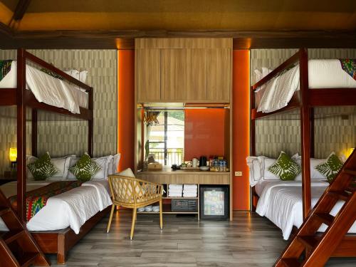 a room with two bunk beds and a desk at Kenjelo Farm and Recreation Resort in Dullan