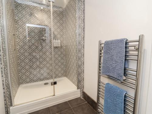 a shower with a glass door in a bathroom at Ferndale in Lynton