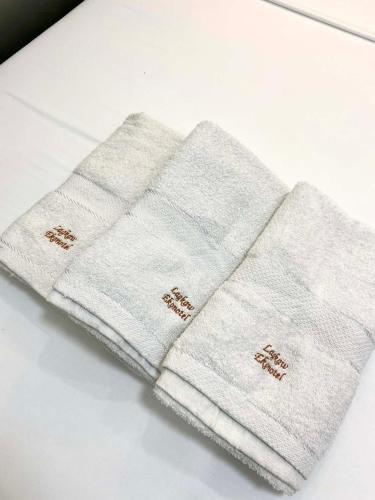 two white towels sitting on top of a table at Lagkaw Ekonotel in Dipolog