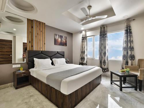 a bedroom with a large bed and a living room at Hotel Delhi Aerocity in New Delhi