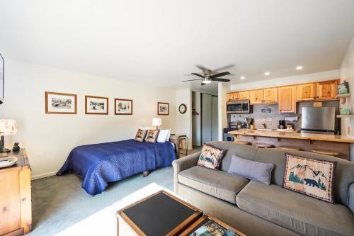 a living room with a couch and a bed at Cozy Studio w/ Partial Lake view #223 at Donner Lake Village in Truckee