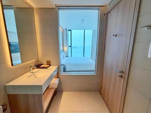a bathroom with a sink and a large window at Căn hộ tại các tòa ICON40 - ALACARTE - NEW LIFE TOWER in Ha Long