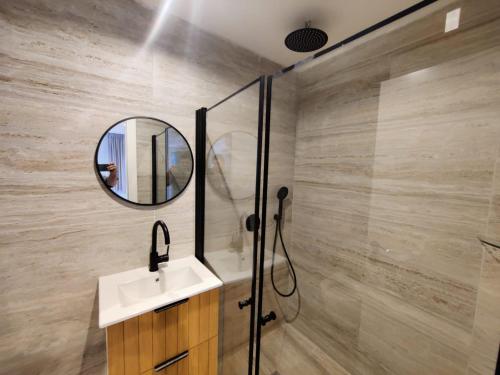 a bathroom with a sink and a mirror at El Yam in Netanya