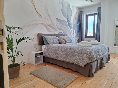 a bedroom with a bed with a mural on the wall at Affittacamere La Polse in Osoppo