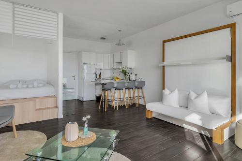 a living room with a couch and a table at Beausoleil near Monaco - Cosy Studio with Sea view in Beausoleil