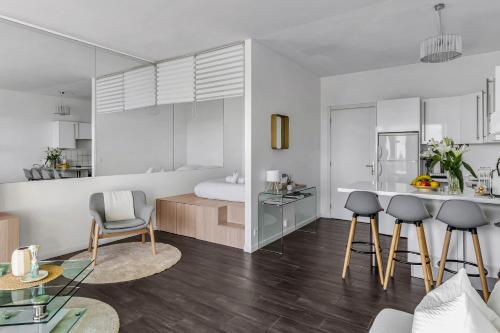 a bedroom with a bed and a kitchen with a table at Beausoleil near Monaco - Cosy Studio with Sea view in Beausoleil
