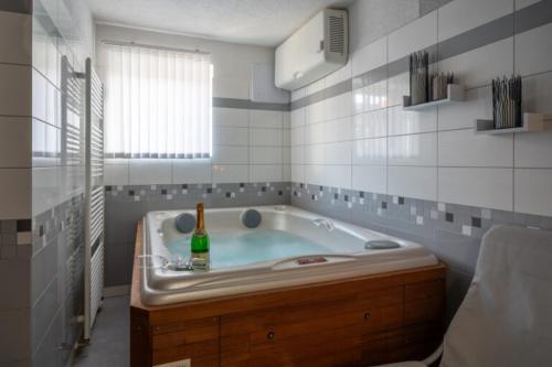 a bathroom with a tub with a bottle in it at Apartmány Sunny hill in Frymburk
