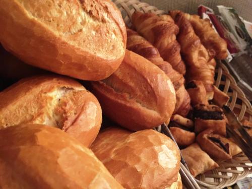 a pile of bread and pastries in a basket at Hotel Restaurant Körber in Osterwald Unterende