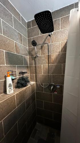 a shower in a bathroom with a tile wall at apartment unit in Spokane