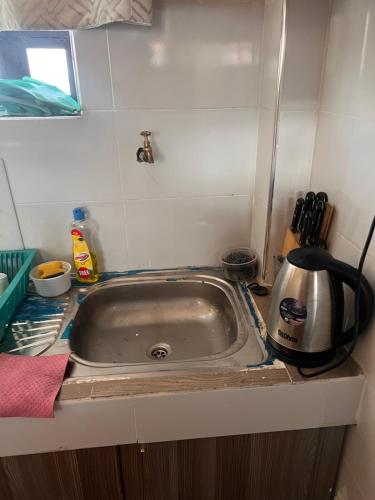 a kitchen counter with a sink in a kitchen at The Mountain Gaze in Nyeri