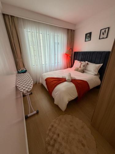 a bedroom with a large bed and a window at Homiq Stays near UN & Village Market - 1 bedroom in Ruaka