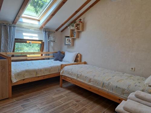 a bedroom with two beds and a window at River Garden in Beli Osŭm