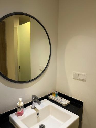 a bathroom with a sink and a large mirror at Putra Hotel at Mydin Tunjong in Kota Bharu