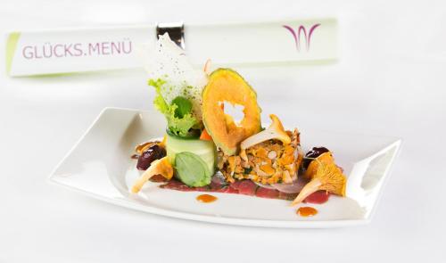 a plate of food on a white plate at Waidringer Hof 4 Sterne Superior in Waidring