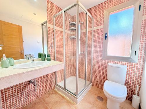 a bathroom with a shower and a toilet and a sink at Villa Solara in Caleta De Fuste