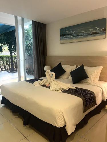 a bedroom with a large bed with a towel on it at Oceanami Resort beach club in Long Hai