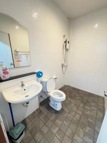 a bathroom with a toilet and a sink at NB Bangsaen House in Ban Puk (2)