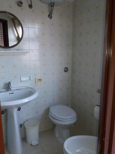 a bathroom with a white toilet and a sink at Albergo Europa in Vittoria