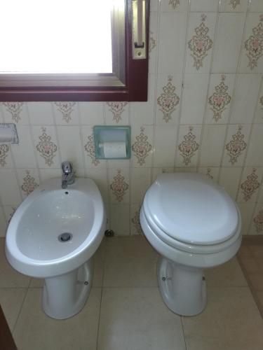 a bathroom with a toilet and a sink at Albergo Europa in Vittoria