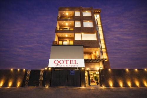 a building with a sign on the front of it at Qotel Comfort Ashok Vihar in New Delhi