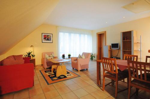 a living room with a table and chairs at Appartements Post Hiddensee, Vitte in Vitte