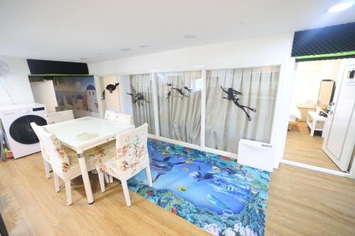 a dining room with a floor that has dolphins on it at FJ House in Keelung