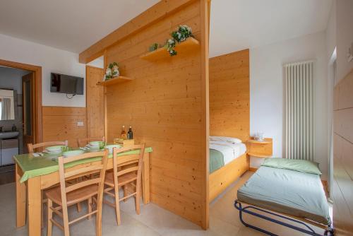 a room with a bed and a table and chairs at Il Nido di Somadino in Casargo