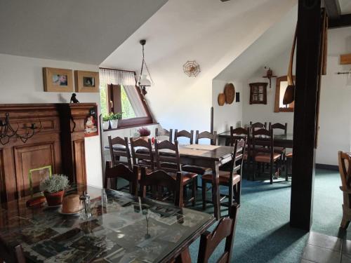 a dining room with a glass table and chairs at Pension Pumperle in Strážný