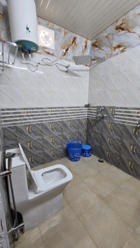 a bathroom with a toilet in a room at Shiv Forest Villas in Pauri
