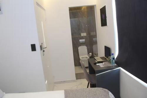 a bathroom with a sink and a desk with a mirror at Willow Brooks in Cape Town