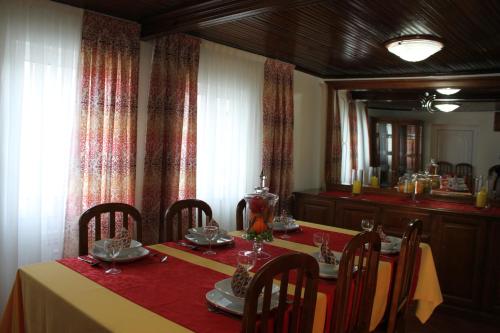 a dining room with a table and a mirror at Casa D'Aldeia in Geres