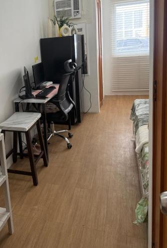 an office with a desk and a computer in a room at Bella's Flats in Bayanihan in Pajak